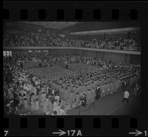 Graduates entering and filling seats during Boston University summer commencement exercises at the War Memorial Auditorium