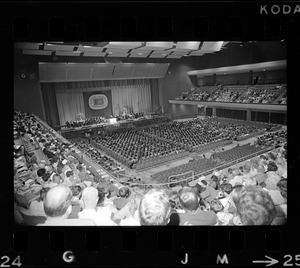 View of stage and seated graduates during Boston University summer commencement at War Memorial Auditorium