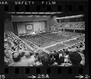 View of stage and seated graduates during Boston University summer commencement at War Memorial Auditorium