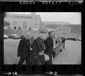Richard Cardinal Cushing, middle, walking with two clergymen before Boston College commencement exercises