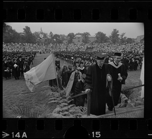 Heading the procession onto the stage at Alumni Field, Boston College, is Henry Lee Shattuck (left foreground) leading Honorary Degree recipients