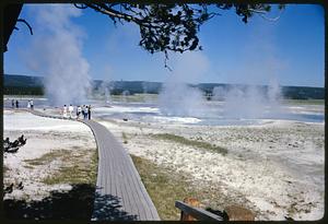 People walking on path through area with hot springs, Yellowstone National Park