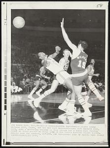 Loose Ball--Seattle SuperSonics player Lenny Wilkens (19), right, and the New York Knickerbockers Dick Barnett (12), left, make a teetering twosome as they strain for a loose ball Tuesday night in third period of their game at New York's Madison Square Garden. Knicks took the contest, 117-104.