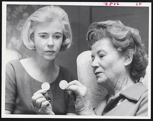 Prestige Coins--Miss Ann Sargent, left, and Miss Eva Adams examine vanishing half-dollars.