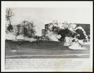 Kent Students Riot. Clouds of tear gas hang over the campus of Kent State University as National Guardsmen [a]ttempt to disperse rioting students. Four persons were killed today [o]n the fourth day of rioting over President Nixon's Southeast Asian [p]olicies.