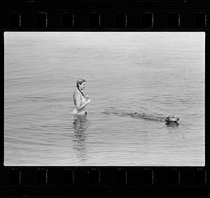 Woman and dog swimming
