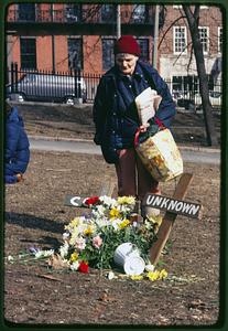 Boston - Boston Common 1982: a woman stands over a memorial for a homeless person who died
