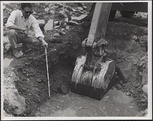 Test pit 3 showing gravel change at 39”, engineer holding tape