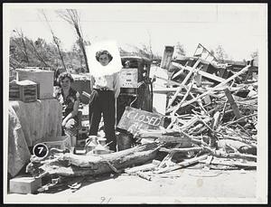 Girls serve milk & coffee & doughnuts for Red Cross, at this wrecked gas station in Holden. L to r. - Nancy Hughes, Charlene Slayton, of Holden