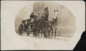 Two horses drawing fire wagon at a fire