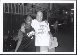 Two young women smiling in front of lockers