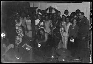 A large group of people, possibly at a party or a performance