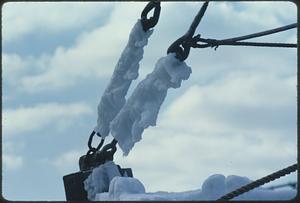 Close view of snow on boat rigging