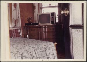 Interior view of bedroom with television, Boston