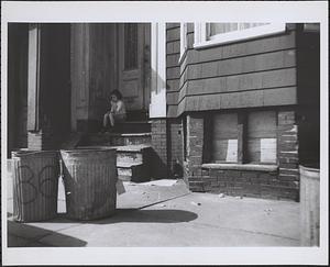Child sitting on stoop, Boston