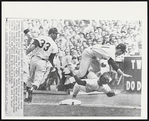 Los Angeles – Big Smashup At First Base – Minnesota second baseman Frank Quilici (top) and the Dodgers’ Maury Wills go flip-flop at first base in the first inning of today’s World Series game as they collided on Wills’ infield grounder to first baseman Don Mincher. Mincher threw to Quilici and Wills was safe with a single. At left is Twins’ pitcher Jim Grant.