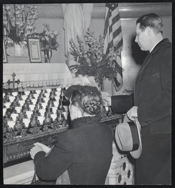 Governor-Elect Tobin at Pre-Inaugural Devotions-After Mass, the governor-elect lights a vigil light (right) at the Shrine of Our Lady of Perpetual Help in the church.