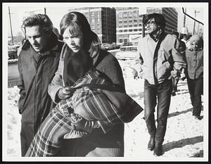 At anti Vietnam demonstration in front of Boston Army Base gate Mrs. Claire Broon with bundled son Niel
