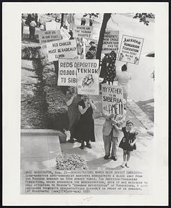 Demonstrators March Near Soviet Embassy--Sign-carrying anti-communist marchers demonstrate a block away from the Russian embassy on 16th street today. The American-Hungarian Federation, which sponsored the demonstration, said it was designed to call attention to Moscow's "inhuman deportation" of Hungarians. A city ordinance prohibits demonstrations directly in front of an embassy.