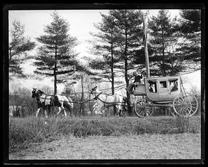 Three people waving from a horse-drawn carriage
