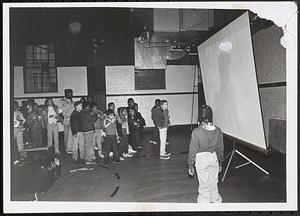 Group of young people watching a screen
