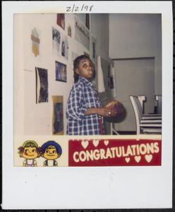 Boy in flannel shirt holding red ball