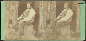 Man Seated in Front of Shack at Trout Farm