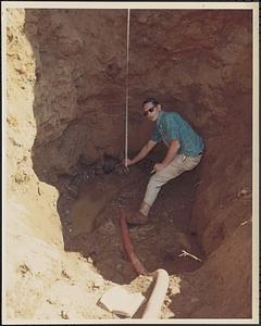 Dam engineer measuring trench