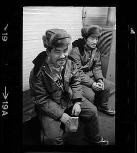 Two seated men in fur hats, North Slope camp, Anchorage, Alaska