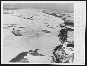 New Cars Frozen-- Twelve barges, in two groups of sic each (shown by arrows) were ice bound today in the Ohio River near here. Eleven of the barges are loaded with 406 new automobiles valued at $500,000. Standard Oil Terminal of Cincinnati, barge owners, says "ay attempt to remove cars across ice to shore if river remains frozen. Kentucky shoreline is shown at right.