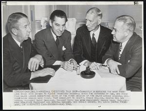 Baseball Executives Talk Shop -- Earnestly discussing the many problems which have arisen to plague organized baseball since the outbreak of war, are these four Major League executives shown at the first session of the Major League baseball meetings which opened here today. They are: (left to right), Eddie Collins, Boston Red Sox general manager; Harry Grabiner, Chicago White Sox vice president; Connie Mack, Philadelphia Athletics president and general manager, and Donald Barnes, St. Louis Browns president.