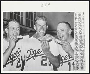 Taking a Big Bite-- These happy Detroit Tigers take a big bite of watermelon in the dressing room after they drove in 10 runs between them in their 12-4 win over the Chicago White Sox in Detroit today. Paul Foytack (left) winning pitcher got two singles and drove in one run. Casey Wise (center) got two home runs, a triple and a single driving in five runs. Lou Berberet hit a grand slam home run. The victory kept the Tigers in American League lead with five consecutive wins and a 1.000 percent average.