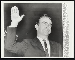 Verlin "Chuck" Gilliam, identified as klaliff of the Columbus, Ohio, klan, takes his oath before the House Un-American Activities Committee 2/11. Gilliam, under arrest in Ohio on armed robbery charge, strode to the witness table in the custody of two deputies. He refused to answer questions.