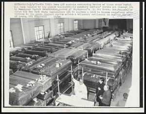 New York: Some 430 caskets containing bodies of those whose burial has been canceled by the almost two-month-old cemetery workers' strike are blessed 3/4 by Monsignor Gustav Schultheiss, pastor of St. Raymond's in the Bronx. Gov. Rockefeller asked the New York State Legislature 3/4 to approve a bill to impose compulsory arbitration in the grave diggers strike unless a voluntary settlement is reached within 48 hours.