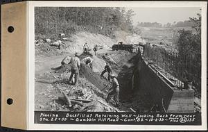 Contract No. 82, Constructing Quabbin Hill Road, Ware, placing backfill at retaining wall, looking back from near Sta. 25+50, Ware, Mass., Oct. 6, 1939