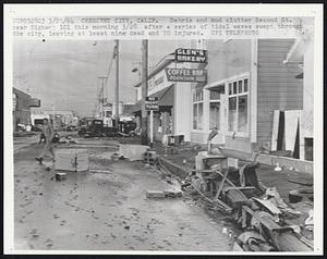Debris and mud clutter Second St. near Highway 101 this morning 3/28 after a series of tidal waves swept through the city, leaving at least nine dead and 70 injured.