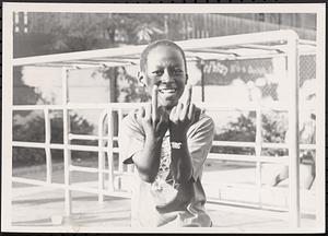 Young boy smiling and gesturing