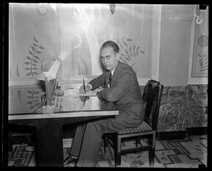Unidentified man holding pen to paper