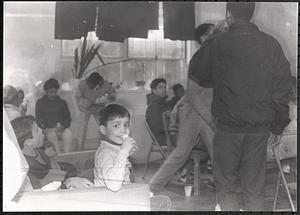 Young boy smiling and taking a sip