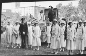 Men and women in front of clock tower