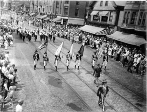 Uncle Sam 18th century marchers with flags band; Dr. Smith Dentist; Woods Creamery