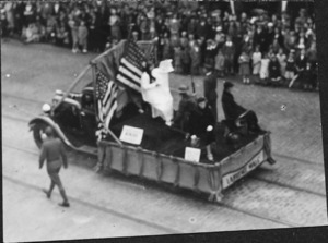 Men dressed in white with large US flag