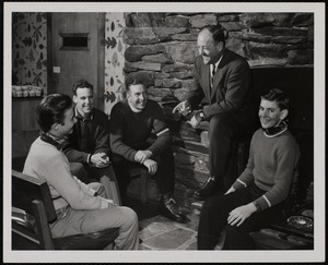 Sepp Ruschp (standing) telling a story in the Mt. Mansfield Toll House to L to R. David White; Bob Bourdon, head of Press Bureau; Kerr Sparks, ski school manager and Peter Ruschp.