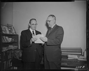 Two men looking at some papers