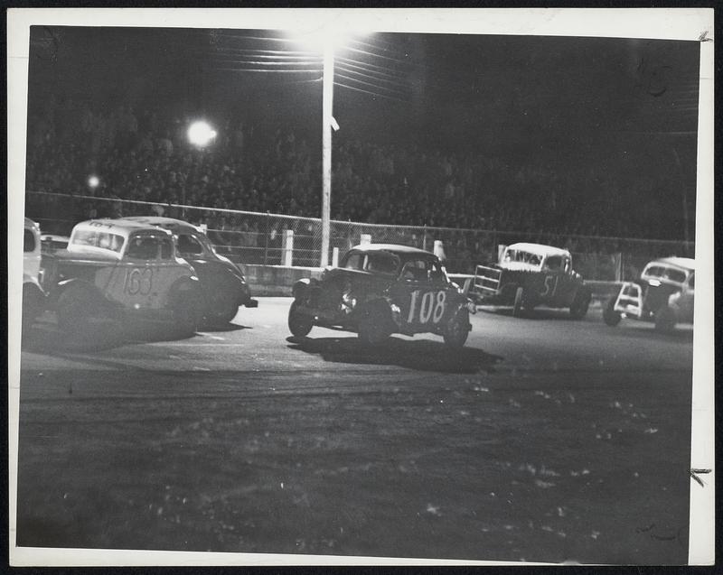 They're Off-Cars move off at start of race and camera catches eerie effect caused by spot lights at the track.