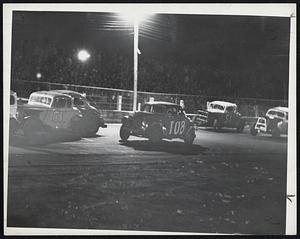 They're Off-Cars move off at start of race and camera catches eerie effect caused by spot lights at the track.