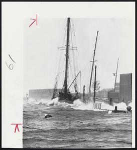 Heavy Seas from Hurricane Donna pound against the Oceanographic Institute ketch "Atlantis" at Woods Hole. Institute buildings are in background.