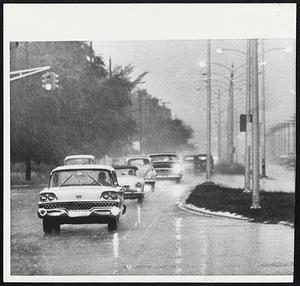 Rain-Darkened Miami as edge of hurricane Donna is felt in Florida city. It was so dark in the driving rain yesterday morning that most cars turned on headlights.