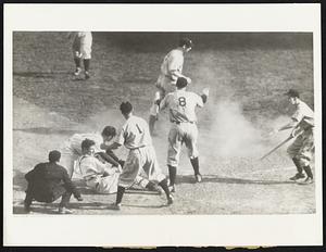 Bill Werber of the Reds tries to aid the dazed Lombardi. The umpire is Babe Pinelli.