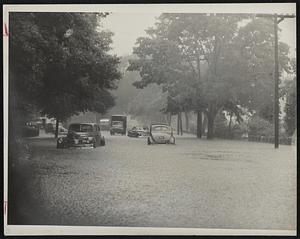 Free Car Wash-Sheets of rain pelt floods on Beacon street, Newton Center.